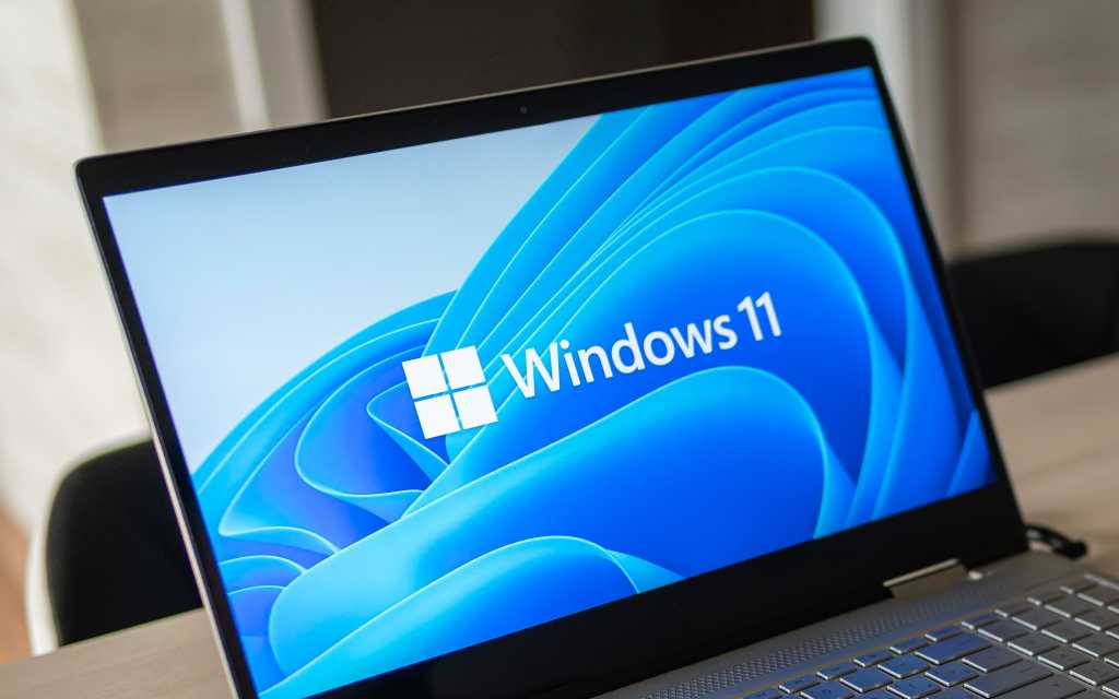 Windows 11 logo on laptop screen. A new operating system update from Microsoft